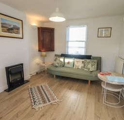 A living room with a sofa and coffee table at Swirl Howe in Keswick