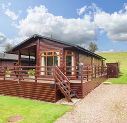 A cabin with a deck and lawn at Badgers Retreat - Two Dales Richmond