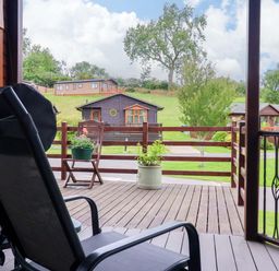 A deck view with a chair and planter at Badgers Retreat - Two Dales, Richmond
