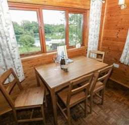 A dining room with a table and chairs at Ash Lodge near Mynydd Cerrig Porthyrhyd