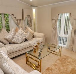 A living room with a sofa and coffee table at The Chalet at Tyn Lon in Chwilog