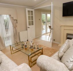 A living room with a sofa and coffee table at The Chalet at Tyn Lon in Chwilog