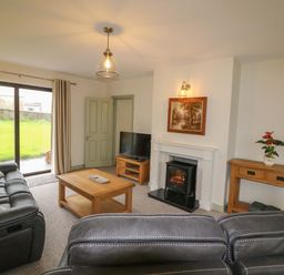 A living room with a sofa and coffee table at Shamrock House