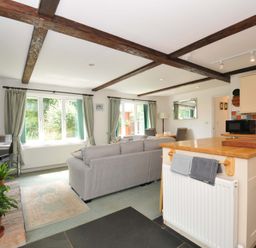A living room featuring a sofa and television at Upper Court Cottage in Broad Langdon near Wainhouse Corner