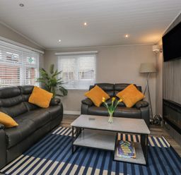 A living room with a sofa and coffee table at Owls Nook Lodge in Langdale 9, White Cross Bay near Windermere
