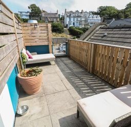An outdoor area with seating and a planter at Awel Deg, Tresaith