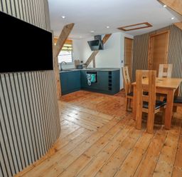 A kitchen with a dining area at Awel Deg, Tresaith