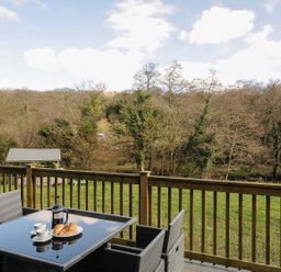 An outdoor seating area with a table and chairs at Pencarrow St Breward