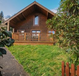 A log cabin with decking and grass at Eden in St Breward
