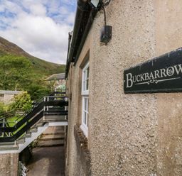 An exterior view of Buckbarrow with stairs and garden in Seascale
