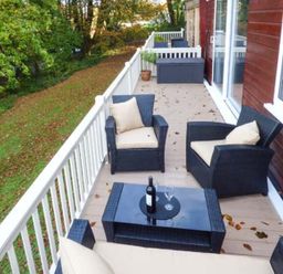 An outdoor seating area with chairs and a table at I C Lundy Too Bideford Bay Holiday Park near Clovelly