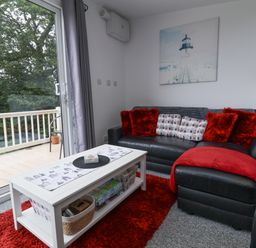 A living room with a sofa and coffee table at I C Lundy Too Bideford Bay Holiday Park near Woolfardisworthy