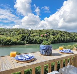 An outdoor dining area with a table and view at Mayhurst in Looe