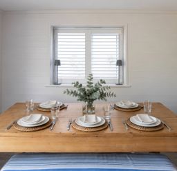 A dining room with a table set for four at Wood Cottage