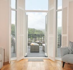 A living room with couches and doors leading to a deck at Overdale
