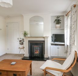 A living room with a fireplace and TV at Dunbrody Dreams