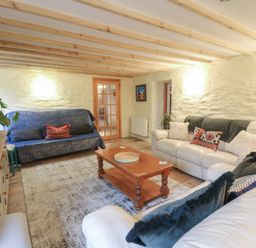 A living room with seating arrangements at Penally Mews in St Dogmaels
