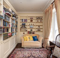 A study with a bookshelf and a sofa at The Old Vicarage in St Issey