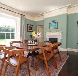 A dining room with a table and chairs at The Old Vicarage in St Issey
