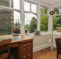 A study with a desk and window view at The Boundary in Windermere