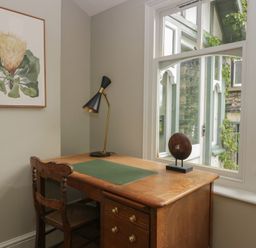 An office with a wooden desk and lamp at The Boundary in Windermere