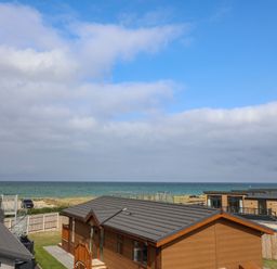 A view of cabins with ocean and sky at Lodge 1 in Norwich