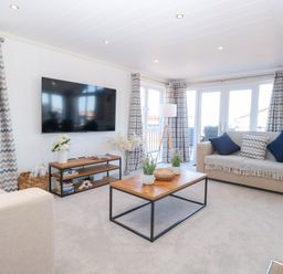 A living room with a television and coffee table at Sandy Snug in Bacton