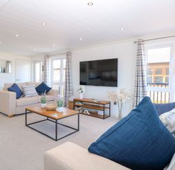 A living room with a television and coffee table at Sandy Snug in Bacton