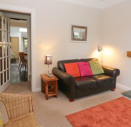 A living room with a sofa and lamp at Cloud Cottage in Ambleside