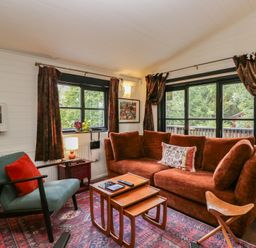 A living room with a sofa and coffee table at Moon Cottage near White Cross Bay Holiday Park near Troutbeck Bridge