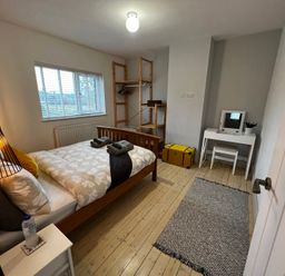 A bedroom with a bed and desk at Dolwen in Caernarfon