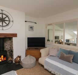 A living room with a fireplace and sofa at 36 Crowthers Hill in Dartmouth