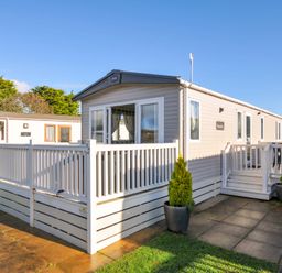 A mobile home with a deck and planter at Eden Way 47 Par