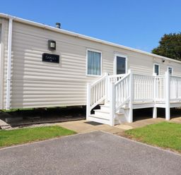 A mobile home with a deck and steps at The Oakley in Par