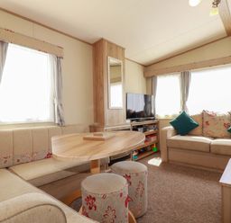 A living room with a sofa and table at The Oakley in Par
