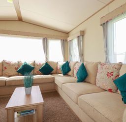 A snug with a sectional sofa and coffee table at The Oakley in Par