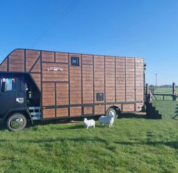 A horsebox parked on grass at GiGi's Horsebox Near Broadway