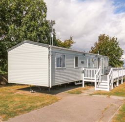 A caravan with steps and parking area at Singh and Leite Family Caravan in St. Osyth