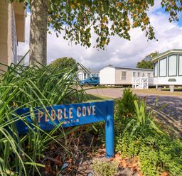 A sign for Pebble Cove at Singh and Leite Family Caravan St. Osyth
