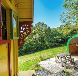 An outdoor area with a table and grill at Prudence in Panson Mill near Ashwater