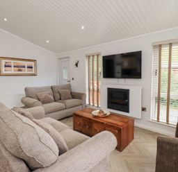 A living room with a sofa and coffee table at Laughing Duck in Troutbeck Bridge