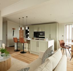A kitchen with a dining area and seating at Costal Lodge at Seaham Hall Seaham