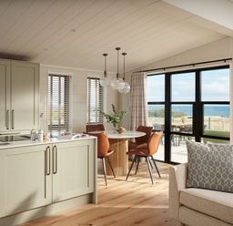 A kitchen with dining area and windows at Costal Lodge at Seaham Hall Seaham