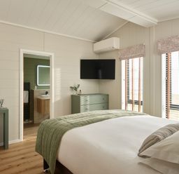 A bedroom with a bed and television at Costal Lodge at Seaham Hall in Seaham