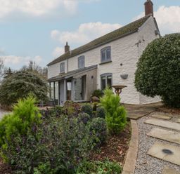 An exterior view of a house with garden and pathway at 3 bed property