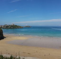 A beach with people and water at Higher Tower Road