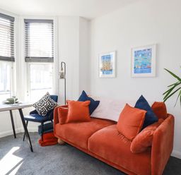 A living room with a sofa and a dining table at Higher Tower Road 