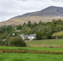A landscape with houses and trees under a mountain at Haulfryn in Dolwyddelan