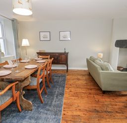 A dining room with a table and chairs at Haulfryn in Dolwyddelan