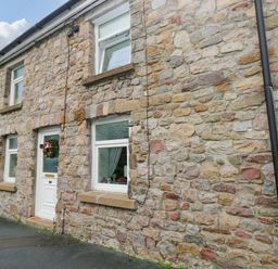 An outdoor view of a stone house at Tawe Cottage in Swansea